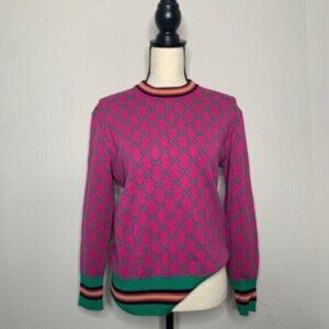 Vibrant Pink Geometric Pattern Sweater with Green Accents and Striped Trim